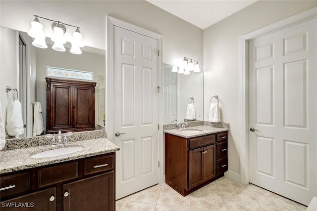 full bathroom with tile patterned flooring, two vanities, and a sink