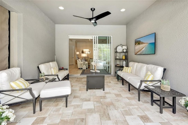 12121 Chrasfield Chase, Fort Myers, FL 33913 - living area with a textured wall, ceiling fan, stone finish floors, and recessed lighting