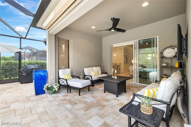 view of patio featuring an outdoor hangout area, ceiling fan, area for grilling, and a lanai