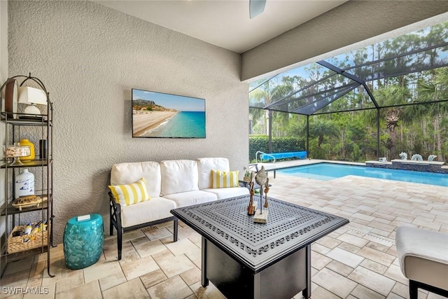 exterior space featuring an outdoor pool, a lanai, and an outdoor hangout area