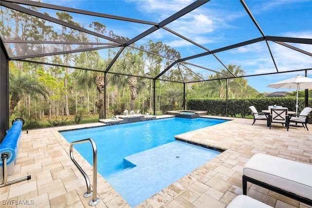 view of swimming pool with a patio, glass enclosure, and a pool with connected hot tub