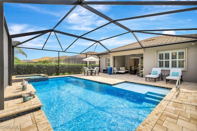 view of swimming pool with a lanai, a patio area, a pool with connected hot tub, and outdoor lounge area