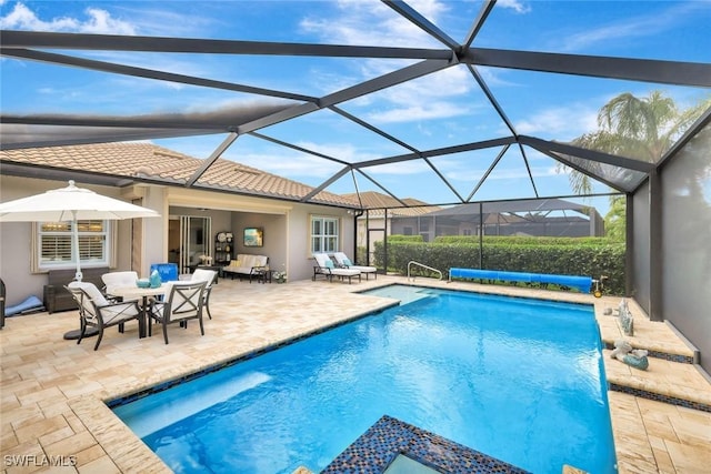 view of swimming pool with a lanai, a patio area, and a covered pool