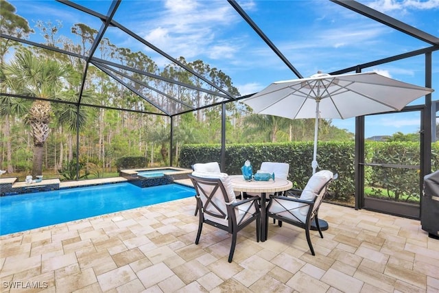 view of swimming pool featuring glass enclosure, a pool with connected hot tub, and a patio