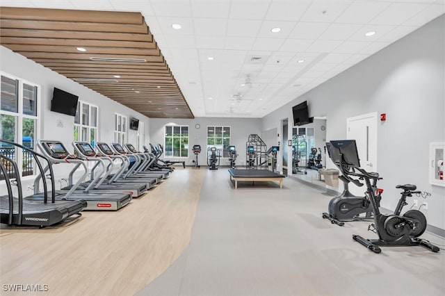 workout area with baseboards, a drop ceiling, and recessed lighting