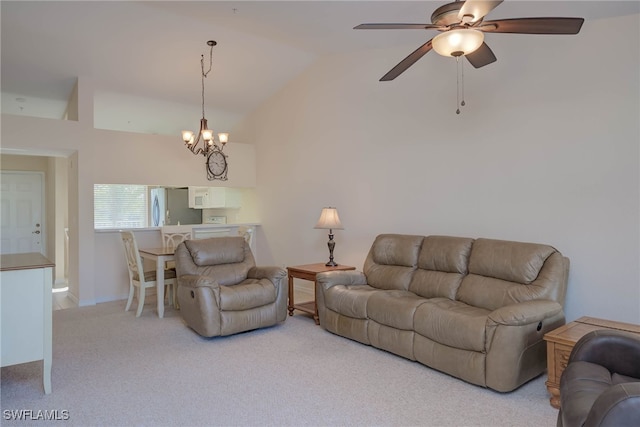 living room with lofted ceiling, carpet, and ceiling fan with notable chandelier