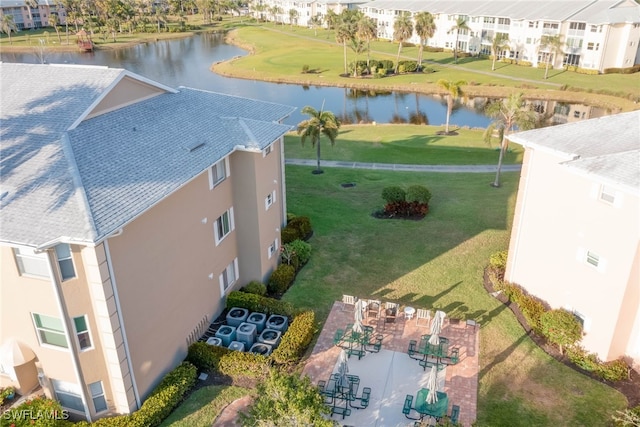 drone / aerial view featuring a residential view and a water view