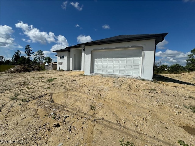 view of property exterior featuring a garage and stucco siding