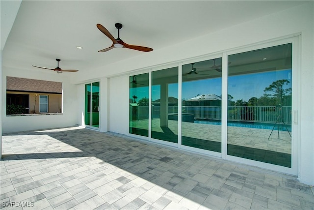 view of patio featuring fence and a ceiling fan