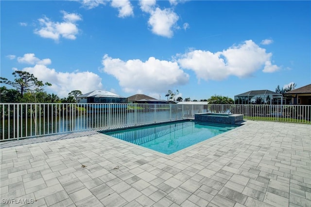 view of swimming pool featuring a pool with connected hot tub, a patio, and fence