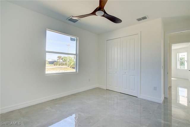 unfurnished bedroom with marble finish floor, baseboards, visible vents, and a closet