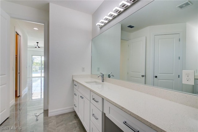 bathroom with marble finish floor, visible vents, vanity, and baseboards