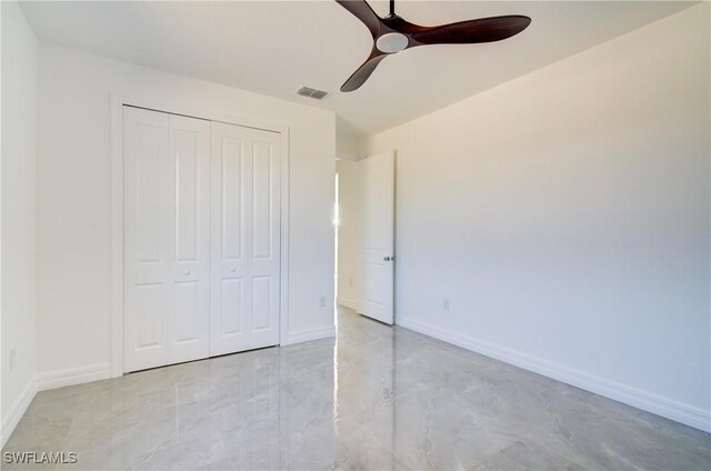 unfurnished bedroom featuring a ceiling fan, baseboards, visible vents, and a closet