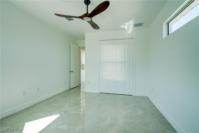 unfurnished bedroom featuring a ceiling fan, a closet, visible vents, and baseboards