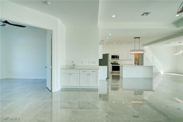 kitchen featuring visible vents, white cabinets, open floor plan, stainless steel appliances, and light countertops