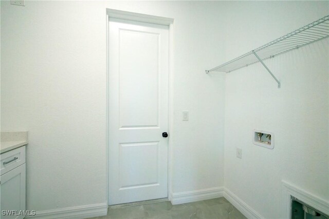 washroom featuring washer hookup and baseboards