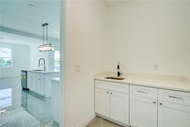 bathroom with marble finish floor, vanity, and baseboards