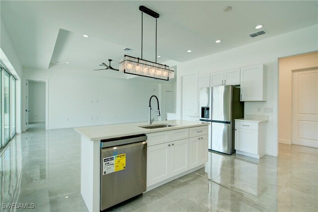 kitchen featuring appliances with stainless steel finishes, a sink, visible vents, and white cabinets