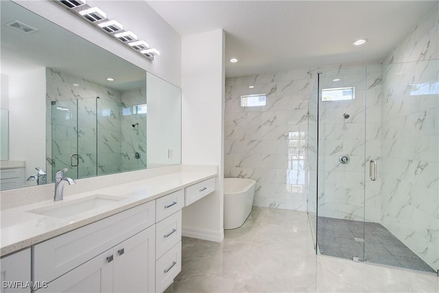 full bathroom with a marble finish shower, visible vents, a freestanding bath, vanity, and recessed lighting