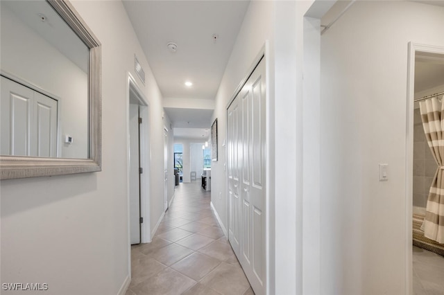 hall featuring light tile patterned flooring, visible vents, recessed lighting, and baseboards