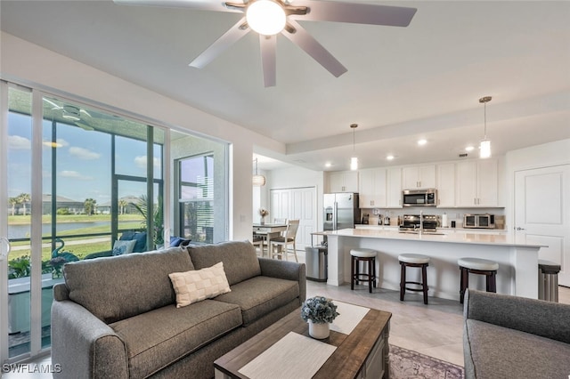 living area with recessed lighting and ceiling fan