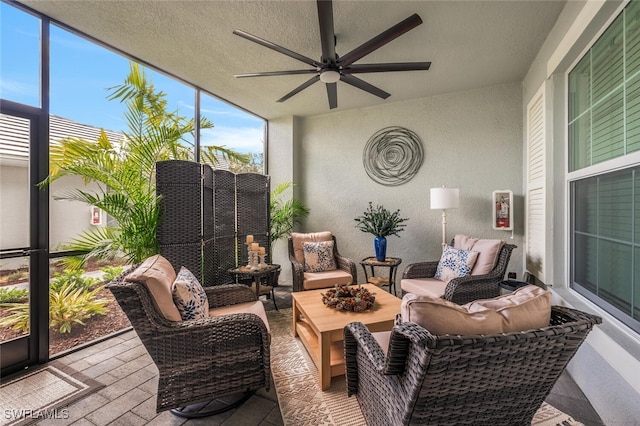 sunroom featuring a ceiling fan