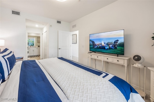 bedroom featuring visible vents and connected bathroom