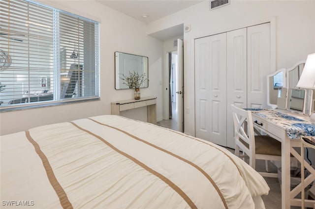 bedroom with visible vents and a closet