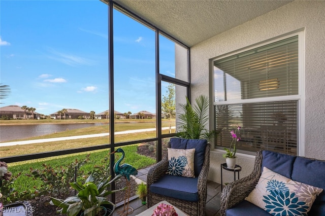 sunroom / solarium featuring a water view