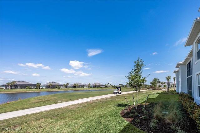 view of yard featuring a residential view and a water view