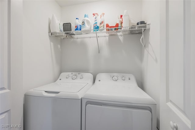 clothes washing area featuring laundry area and washing machine and clothes dryer