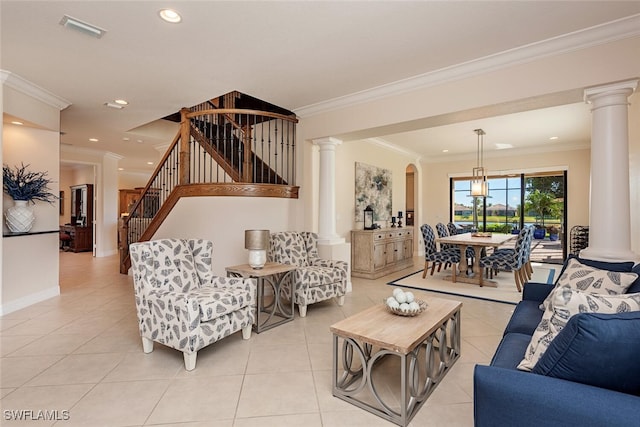 living area with light tile patterned floors, decorative columns, visible vents, and stairs