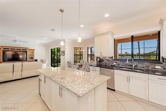 kitchen featuring a center island, ornamental molding, decorative backsplash, light tile patterned flooring, and stainless steel dishwasher