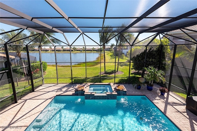 view of pool featuring glass enclosure, a patio, a yard, and a water view