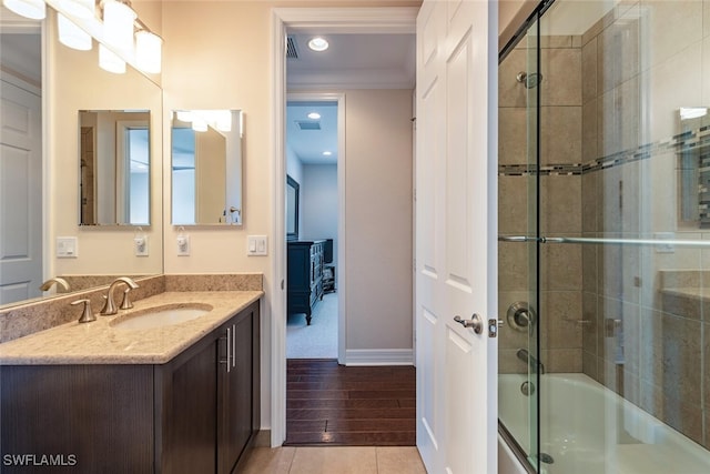 full bath with ornamental molding, recessed lighting, baseboards, bath / shower combo with glass door, and vanity