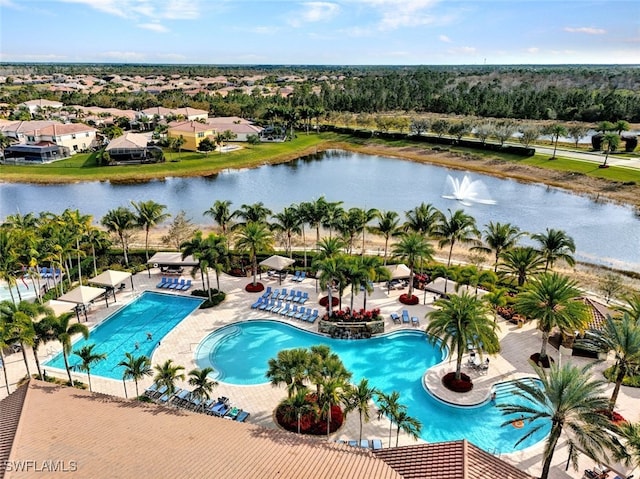 pool featuring a water view, a patio, and fence