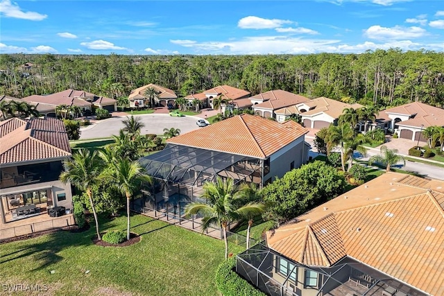 aerial view featuring a view of trees and a residential view