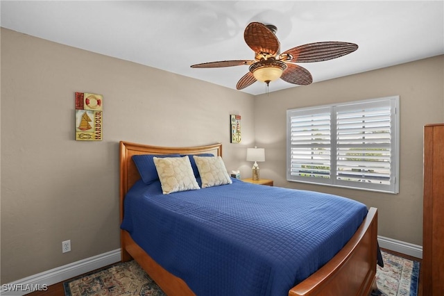 bedroom with ceiling fan and baseboards