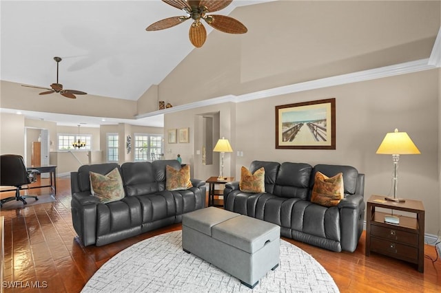 living area featuring baseboards, high vaulted ceiling, wood finished floors, and ceiling fan with notable chandelier