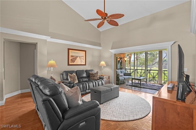 living area with ceiling fan, high vaulted ceiling, baseboards, and wood finished floors