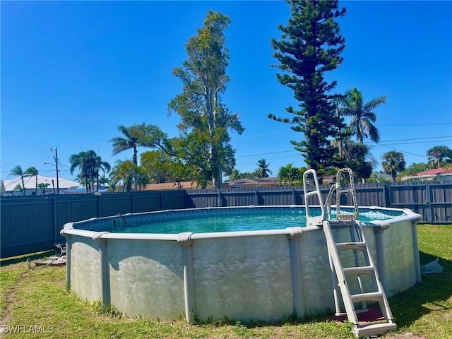 view of swimming pool with a fenced backyard and a fenced in pool