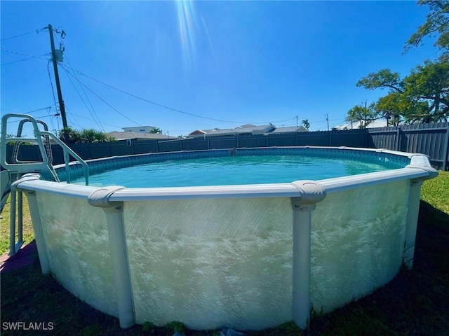 view of swimming pool featuring a fenced backyard and a fenced in pool