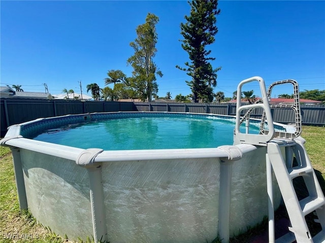 view of swimming pool with a fenced backyard and a fenced in pool