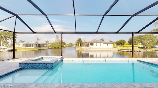 outdoor pool with an in ground hot tub, a patio, a water view, and a lanai