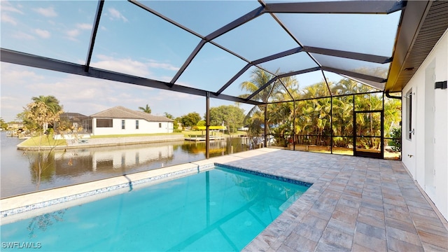 outdoor pool with a patio area, a water view, and a lanai