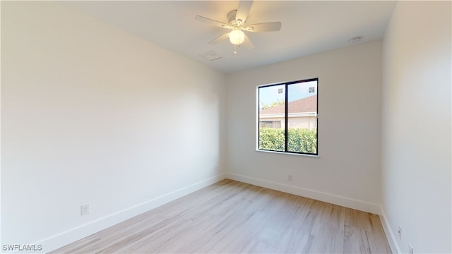 unfurnished room with light wood finished floors, baseboards, and a ceiling fan