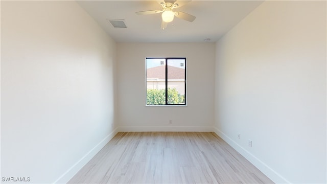 unfurnished room featuring baseboards, visible vents, light wood-style flooring, and a ceiling fan