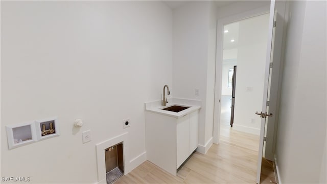 clothes washing area featuring laundry area, gas dryer hookup, hookup for a washing machine, electric dryer hookup, and a sink