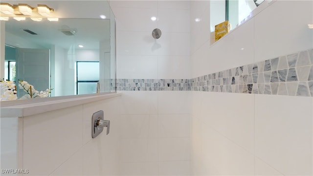 bathroom featuring visible vents and a walk in shower