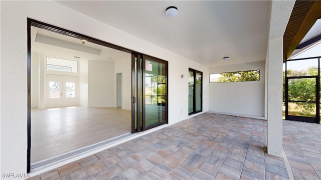 view of patio featuring french doors and a lanai